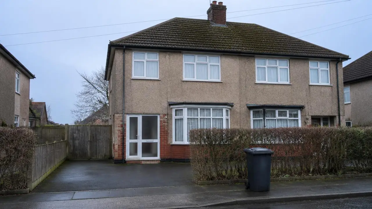 Semi-detached UK house with closed curtains on a grey winter morning