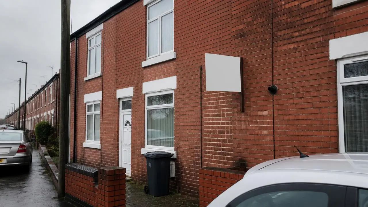 Red brick terraced rental house with a To Let board outside
